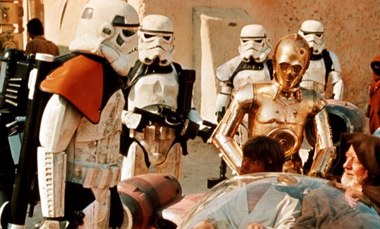 Stormtroopers question Luke Skywalker (Mark Hamill) and Obi-Wan Kenobi (Alec Guinness) on Tatooine in 1977