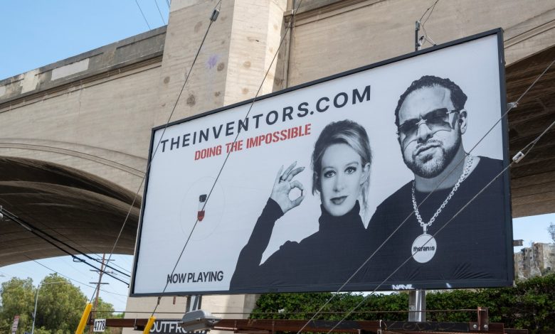 Those Elizabeth Holmes Billboards That Are Popping Up All Over Town? Meet the Mystery Man Behind Them