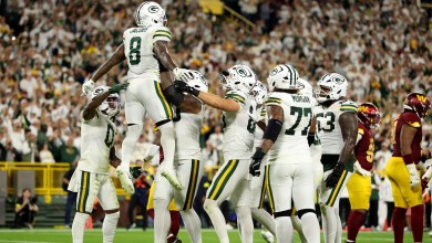 Josh Jacobs #8 of the Green Bay Packers celebrates with his teammates after scoring a touchdown against the Washington Commanders on Sept. 11, 2025.