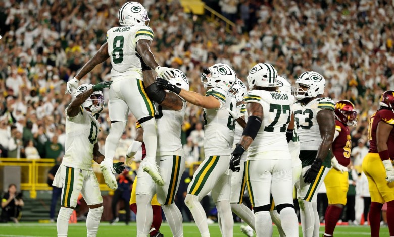 Josh Jacobs #8 of the Green Bay Packers celebrates with his teammates after scoring a touchdown against the Washington Commanders on Sept. 11, 2025.