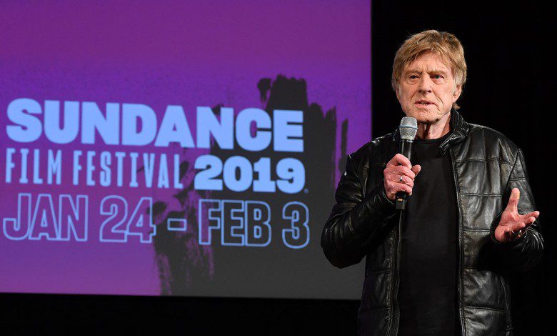 Robert Redford at Sundance 2019 speaking with a microphone in hand.