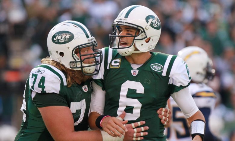 EAST RUTHERFORD, NJ - OCTOBER 23: Mark Sanchez #6 of the New York Jets is congratulated on a touchdown pass by teammate Nick Mangold #74 against the San Diego Chargers at MetLife Stadium on October 23, 2011 in East Rutherford, New Jersey. (Photo by Nick Laham/Getty Images)