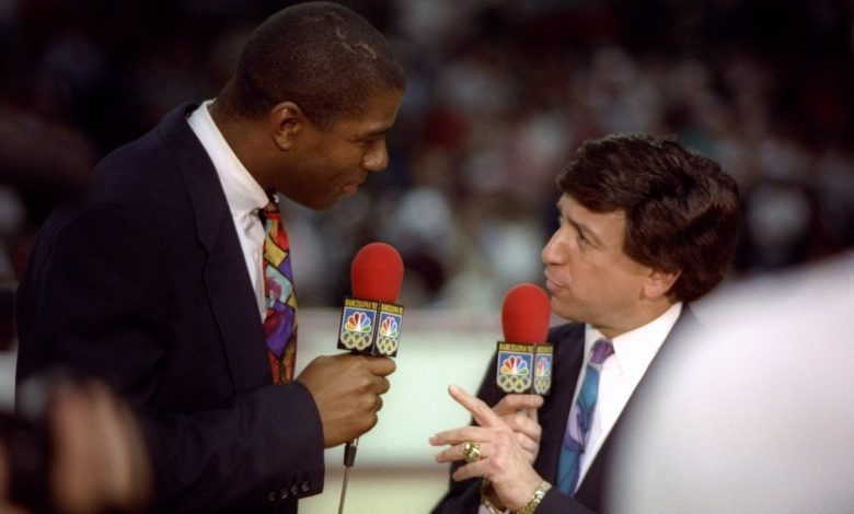 17 May 1992: NBC sportscaster Marv Albert and Earvin Magic Johnson talk during a game between the Chicago Bulls and the New York Knicks at the United Center in Chicago, Illinois.