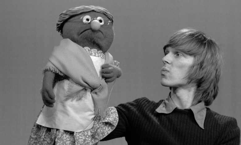 Puppeteer Daniel Seagren holds Muppet Grandmother Happy during