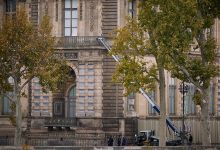 Police and Crime scene officers secure a furniture elevator extended to the balcony of a gallery at the Louvre Museum on October 19, 2025 in Paris, France.