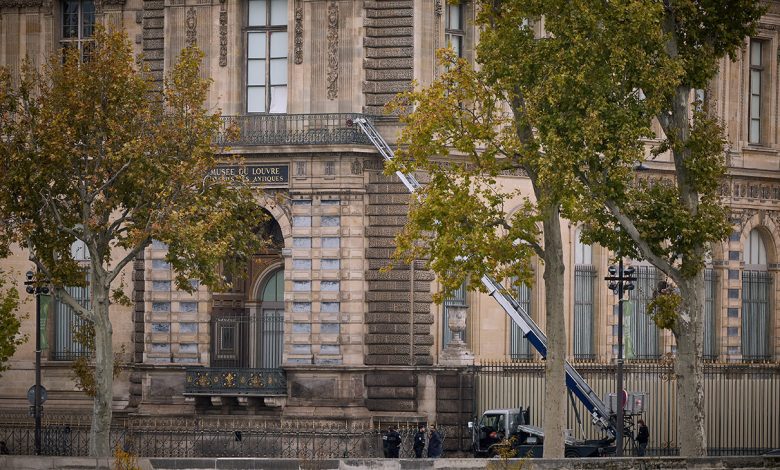 Police and Crime scene officers secure a furniture elevator extended to the balcony of a gallery at the Louvre Museum on October 19, 2025 in Paris, France.