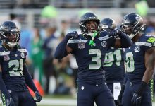 Devon Witherspoon (#21) of the Seattle Seahawks and Nick Emmanwori (#3) react to a play during the first quarter of Super Bowl LX against the New England Patriots at Levi