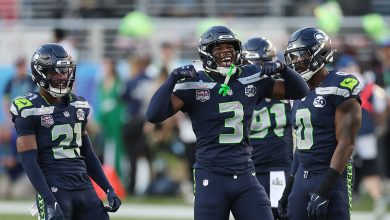 Devon Witherspoon (#21) of the Seattle Seahawks and Nick Emmanwori (#3) react to a play during the first quarter of Super Bowl LX against the New England Patriots at Levi