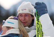 Bronze medalist Sturla Holm Laegreid of Team Norway is embraced by Ingrid Landmark Tandrevold of Team Norway after the medal ceremony for the Men