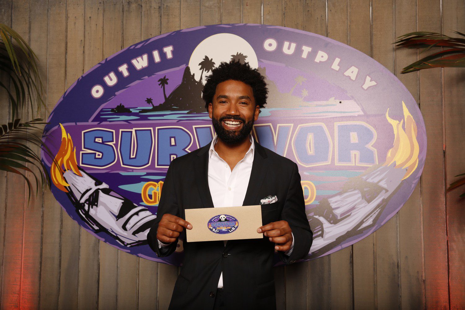 Wendell Holland poses with his check after winning 'Survivor.'