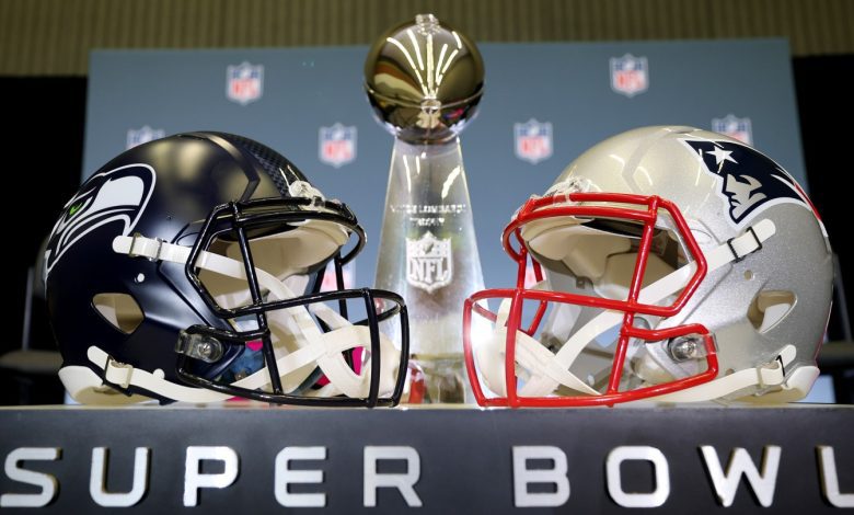 The Vince Lombardi Trophy is framed by the Seattle Seahawks and New England Patriots helmets during Super Bowl LX Opening Night at San Jose McEnery Convention Center on February 2, 2026 in San Jose, California.