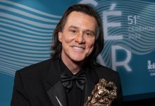 Jim Carrey poses with the Honorary Cesar Award backstage during the 51st Cesar Film Awards at L