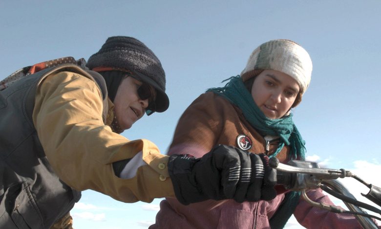 Cutting Through Rocks, Sarah Shahverdi (left) trains Fereshteh to ride a motorcycle, 2025.